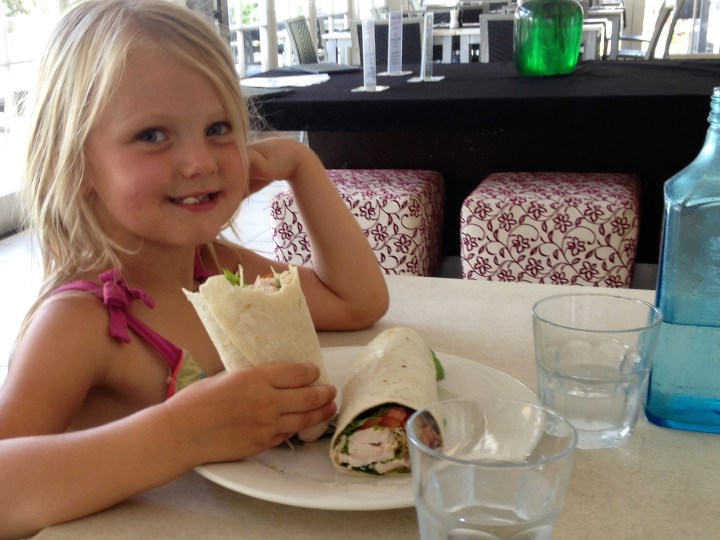 Ainsley eating lunch, using porcelain plate and glass jug and cup.