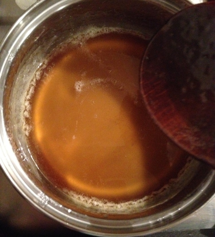 Honey coloured sugaring paste ready to be transferred to a glass container.