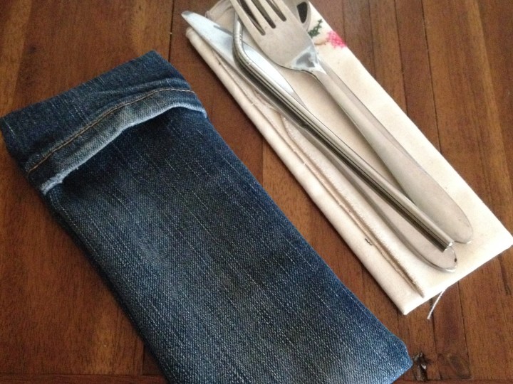 Finished denim cutlery pouch with reusable napkin, straw and cutlery.