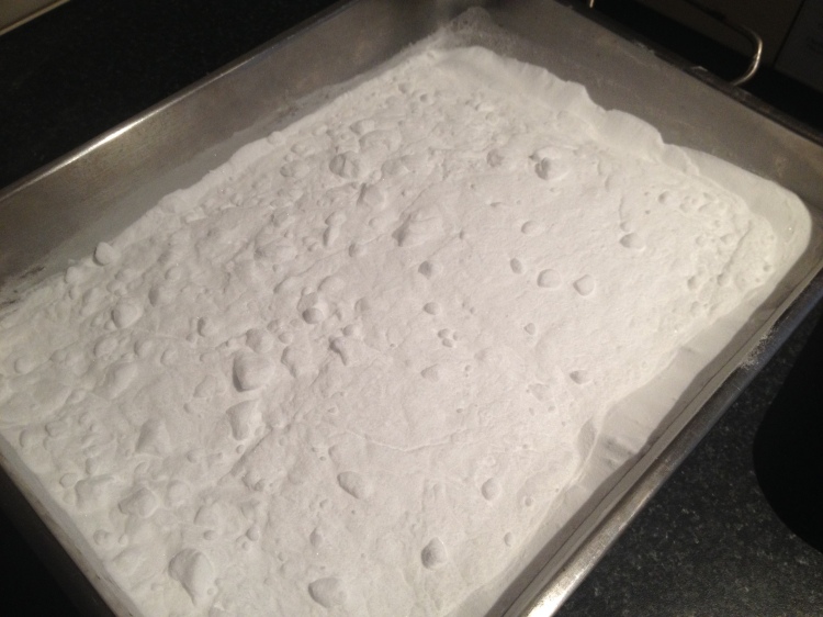Turning baking soda into washing soda on a tray in the oven.