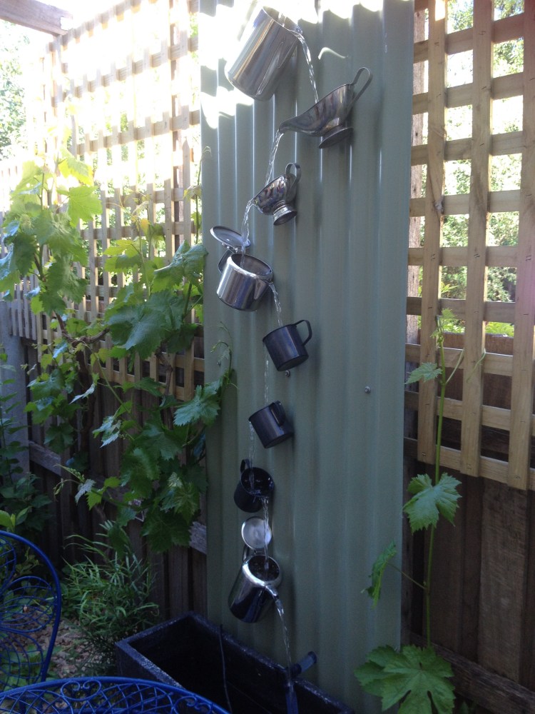 A water feature made from jugs and cups.