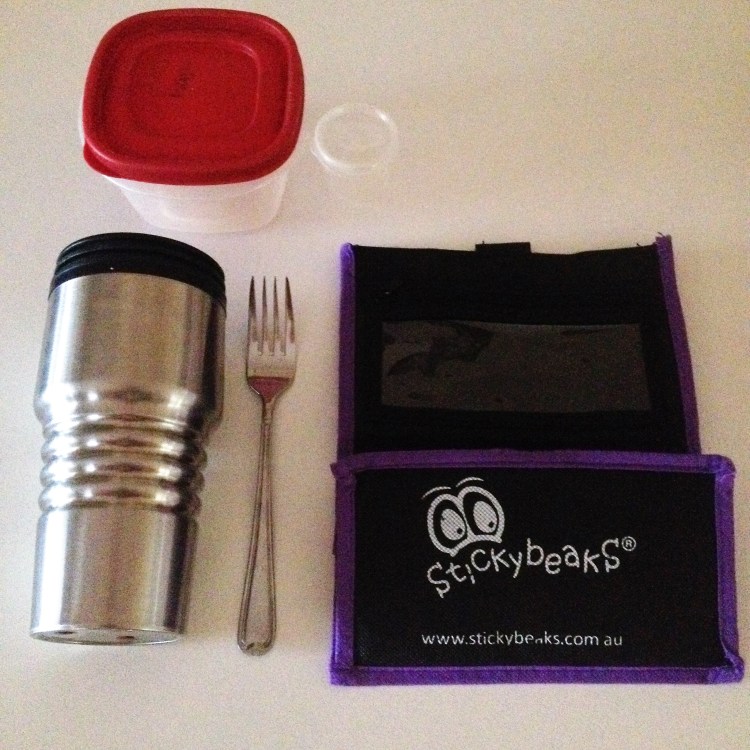 Reusable lunch order ttols for waste free lunches. Includes a reusable bag, travel mug, fork and small plastic tubs.