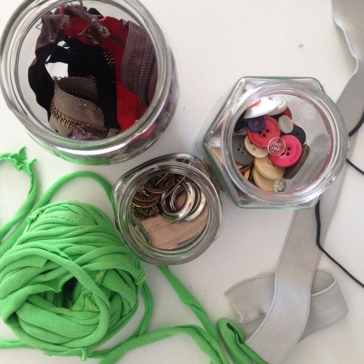 Reusable parts collected from clothing before repurposing or composting.