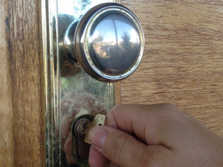 Unlocking door to new home.