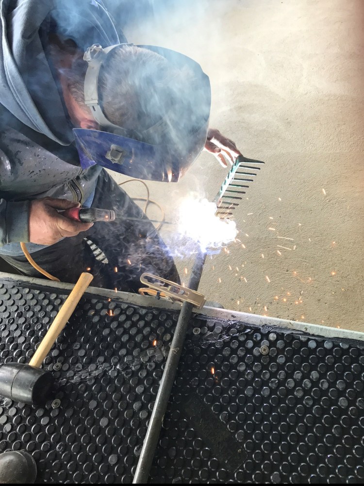 Welding a steel handle onto my garden rake.