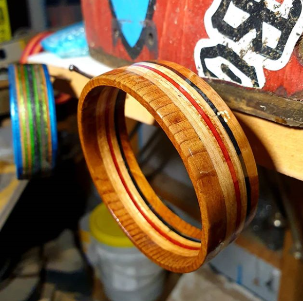 A bangle made from upcycled broken skateboards hanging on a nail in The Hairy Handyman's workshop.